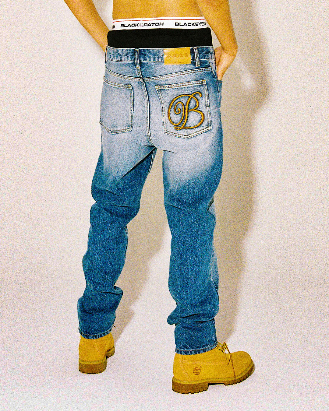 B EMBLEM SLIM FIT JEANS